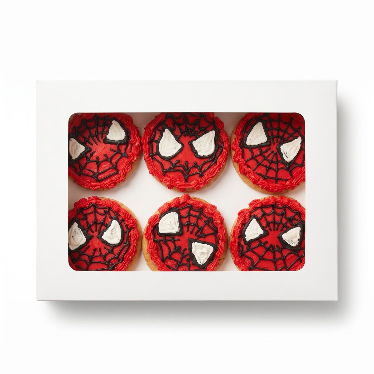 A box of six round sugar cookies iced as red-and-black webbed masks.